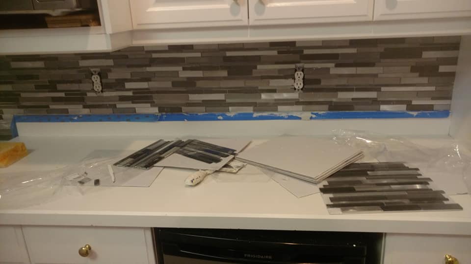 Backsplash tile install on a kitchen wall.