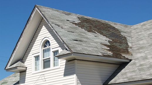 An image of a house with a roof in disrepair