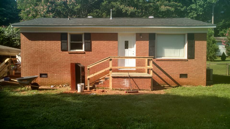 New step banister, secured and painted shutters, painted door, pressure-washed exterior brick.